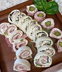 Image of pickle wraps and meat pinwheels at funeral luncheon reception